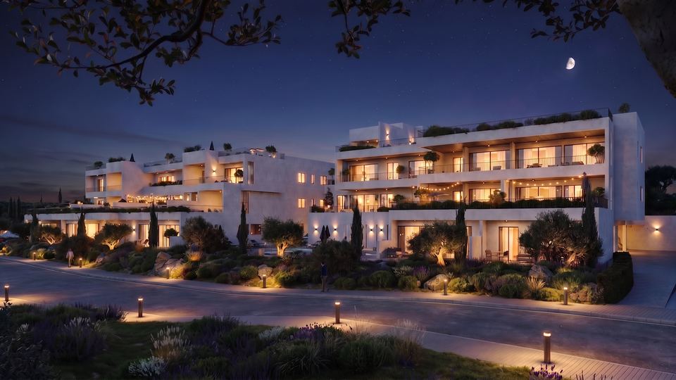 The development lit at night under a crescent moon