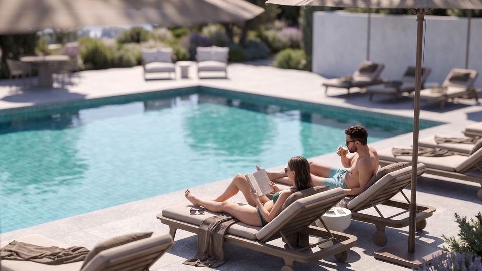 A couple relaxing on loungers beside the pool